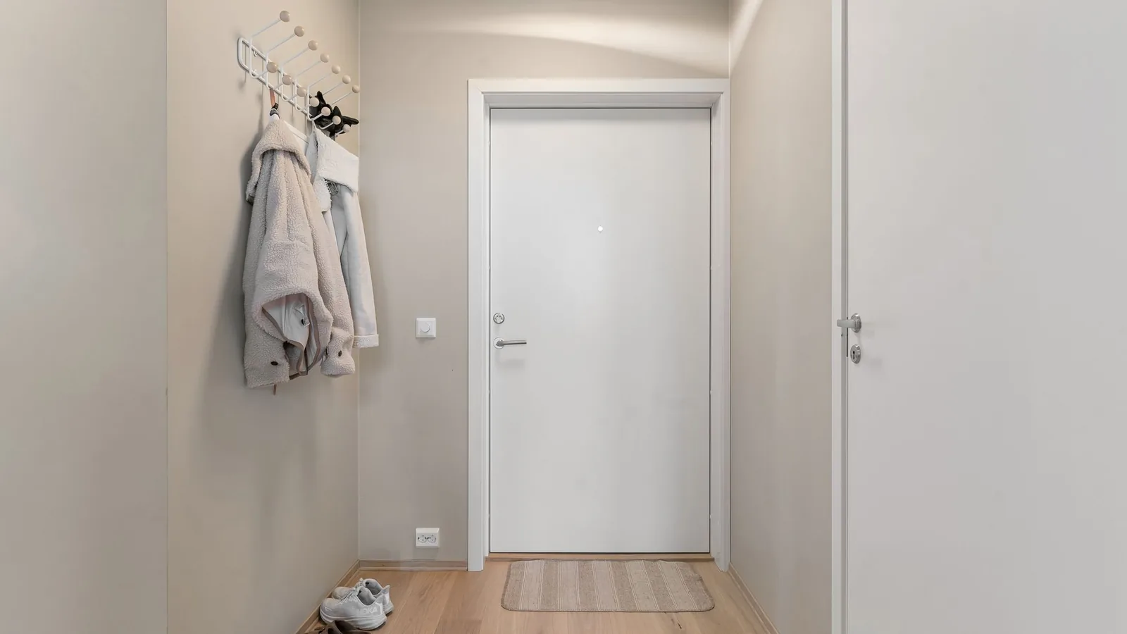 The front door of an apartment seen from the hallway inside