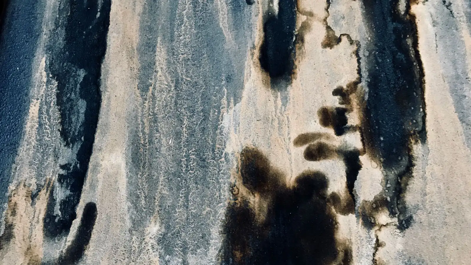 Dark mildew stains spreading across a wall